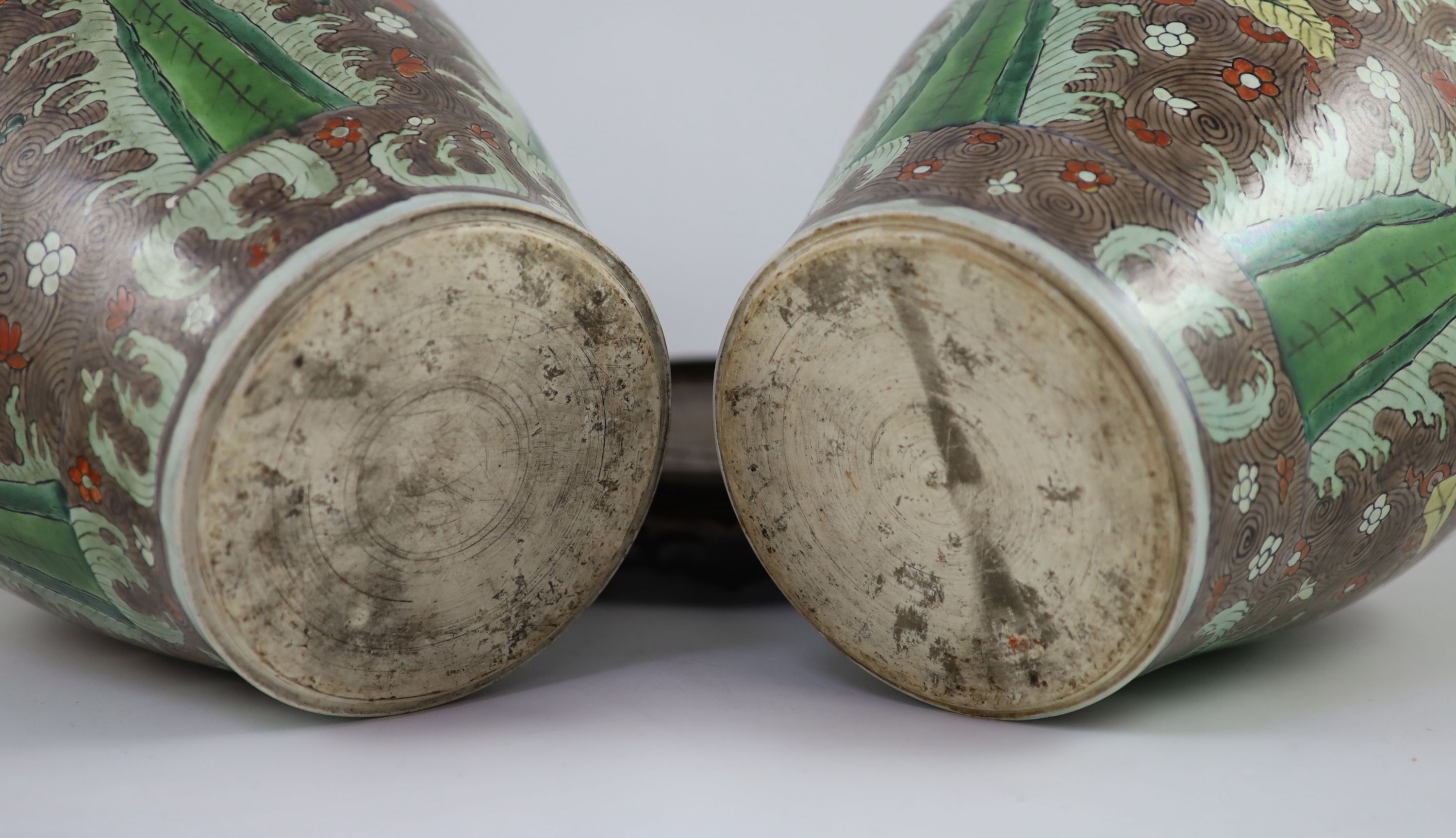 A pair of Chinese enamelled porcelain jars and covers, in Transitional style, 34cm high, wood stands